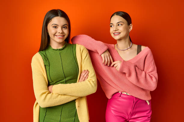 istock Two friends stand confidently in colorful sweaters, sharing joyful conversations and laughter 2183644683