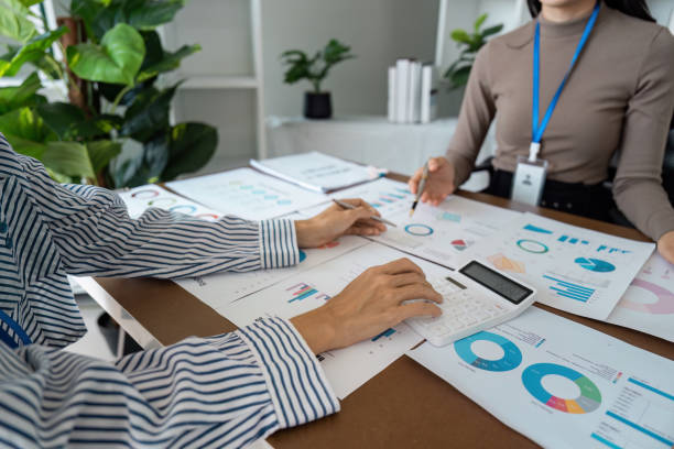 istock Collaborative Business Meeting with Charts and Calculator in a Modern Office Setting 2183644711
