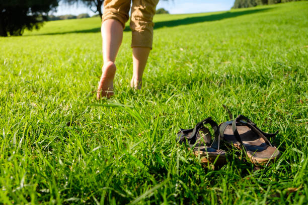 istock Woman walking on the grass barefoot. grounding / earthing 2183646255