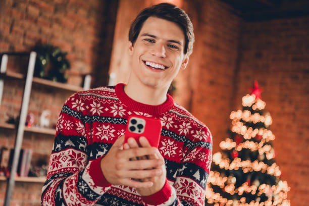 istock Photo of funky cool guy dressed ornament pullover enjoying x-mas day communicating modern gadget indoors house apartment room 2183646330