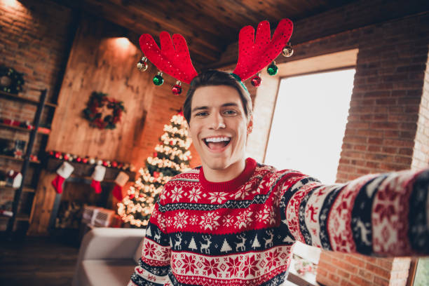 istock Photo of cheerful positive guy dressed ornament pullover tacking selfie enjoying x-mas eve indoors house apartment room 2183646432