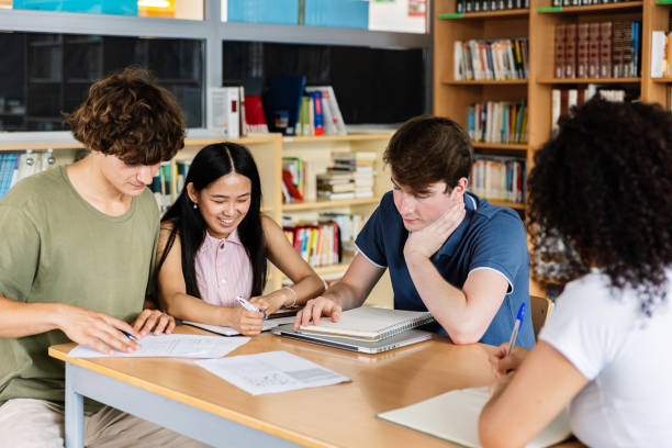 istock Young group of multiracial high school students learning together at library 2183646546