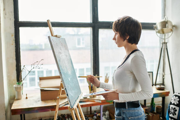 istock A young woman passionately painting in a bright studio filled with inspiring creativity 2183646547