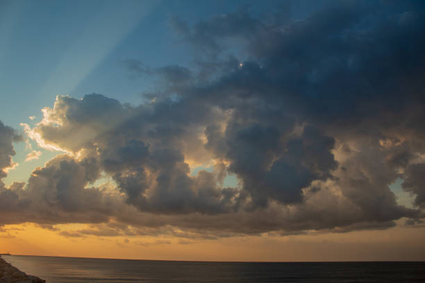 Sky during overcast, storm at evening consist of many gray clouds, empty space, light of nature, sunset sunrise, horizon skyline, land or landscape at outdoor contryside for background and concept of disaster, danger, promised.