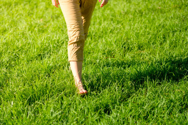 istock Woman walking on the grass barefoot. grounding / earthing 2183646851