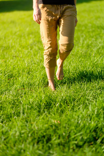 istock Woman walking on the grass barefoot. grounding / earthing 2183646932