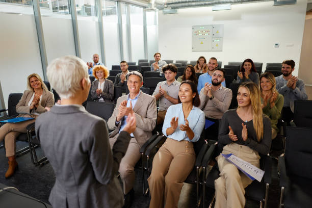 istock Happy business people applauding on a seminar in board room. 2183647826
