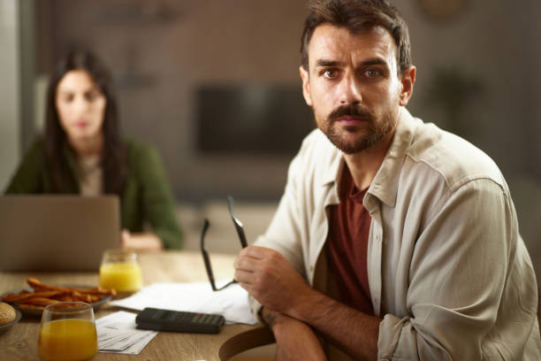 istock Serious man working on financial bills at home. 2183648944