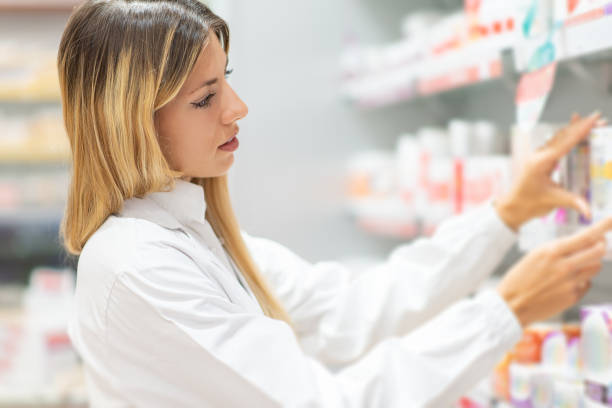 istock Pharmacist arranging medicine on pharmacy shelves 2183648975