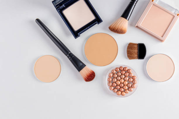 istock a set of cosmetic decorative makeup products in various packages and several brushes for applying makeup. white background. top view. beauty concept 2183654120