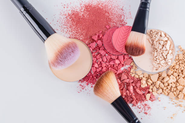 istock Chic cosmetic brushes lie on dry samples of loose blush and different tones powder. texture of decorative cosmetics. top view. close up. 2183654237