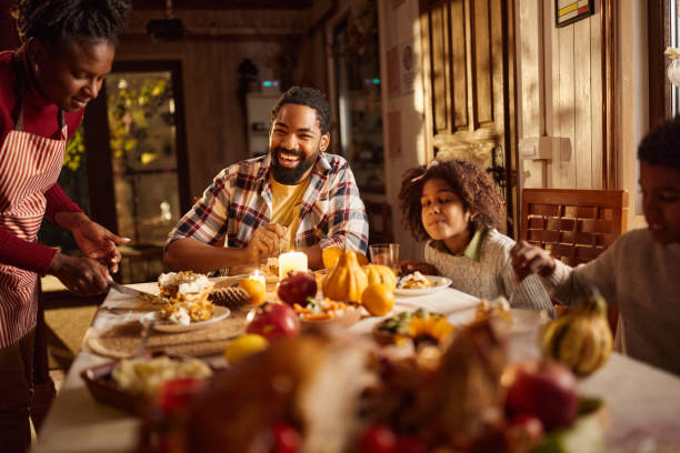 istock Happy black family enjoying in a meal at dining table. 2183655324