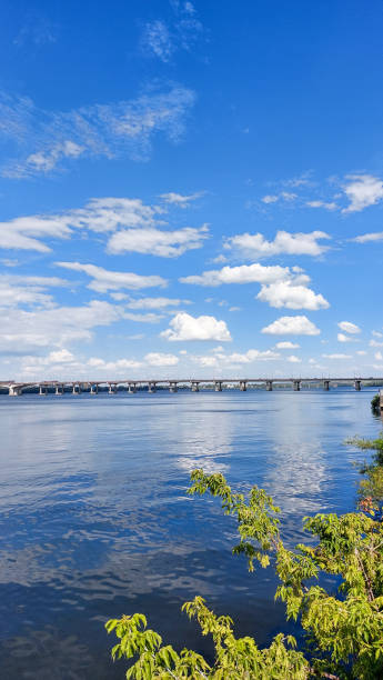 istock Expansive Bridge Over a Calm River Under a Vibrant Blue Sky 2183662494
