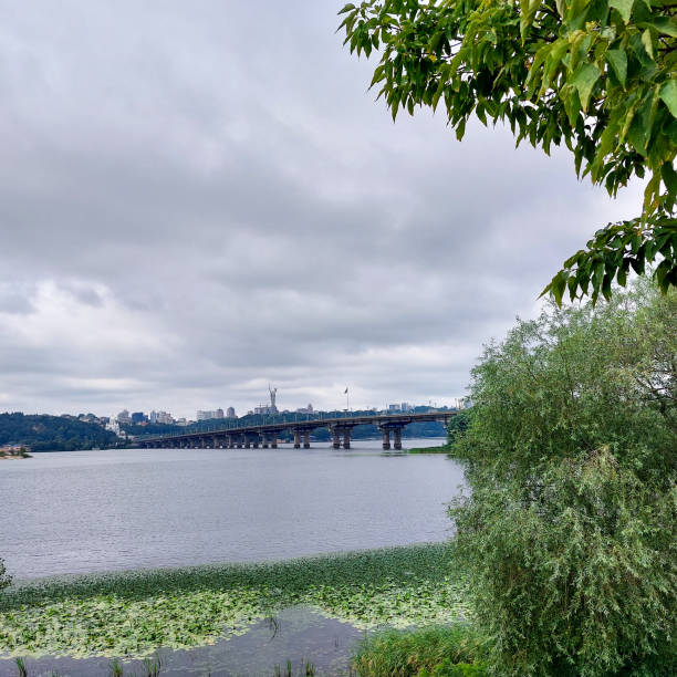 istock River Scene with Bridge, City Skyline, and Overcast Sky 2183662507