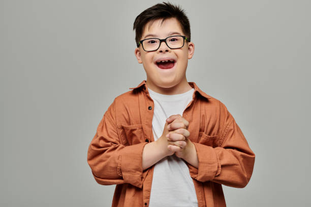 istock Joyful boy with Down syndrome smiling brightly in a cheerful indoor setting 2183663080