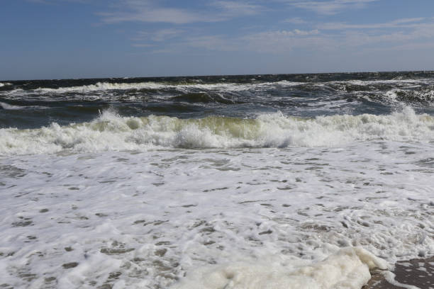 istock Powerful Ocean Waves Crashing on Sandy Shoreline with Sea Foam 2183663225