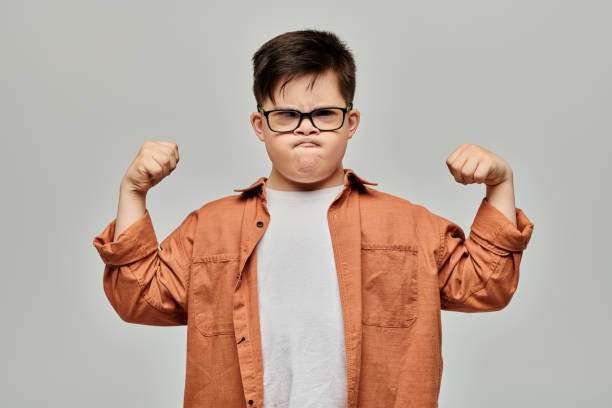 istock A determined boy with Down syndrome shows his strength and confidence in a simple studio setting 2183664000