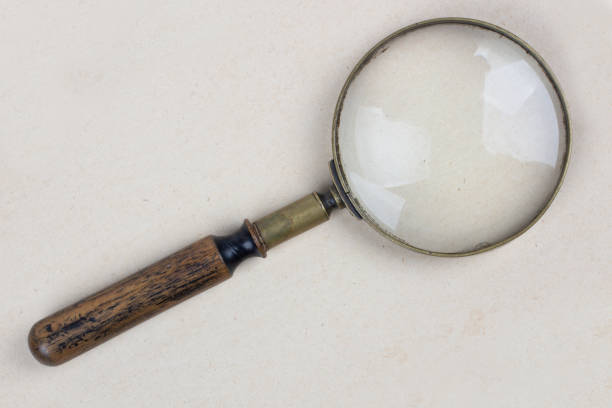 istock Antique magnifying glass on paper 2183664395