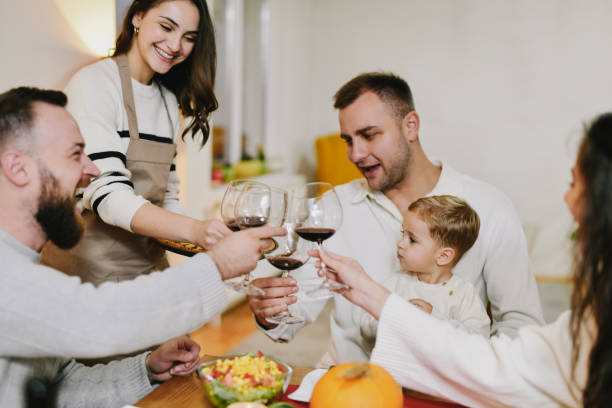 istock Joyful Young Family Making Toast With Wine Enjoying Dinner Together 2183669440