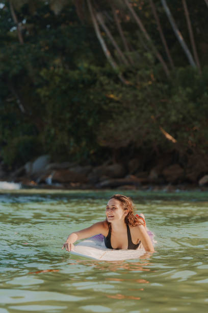 istock Woman surfing on Sri Lanka at sunset 2183673595
