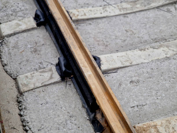 istock precise laying of tracks using leveling devices at the fork in two tram tracks. a layer of gravel above which concrete sleepers are placed. rubber anti-vibration base made of rubber, edgeinsreuction 2183679780