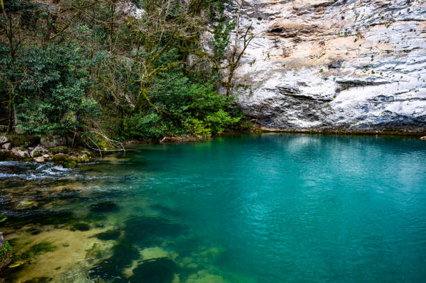 istock beautiful blue lake surrounded by a rocky cliff 2183684010