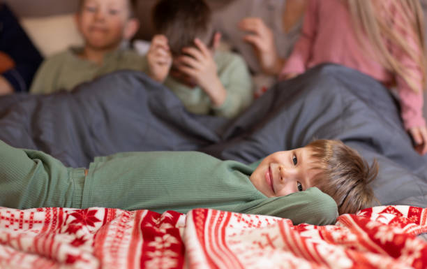 istock A happy little boy is lying on the bed 2183685080