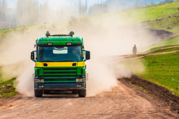 istock Pedestrian in dust cloud from truck on dirt road 2183685220