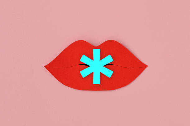 istock Paper lips cut-out with asterisk symbol on pink background - Concept of gender issues, reference mark; censorship of offensive words 2183685654