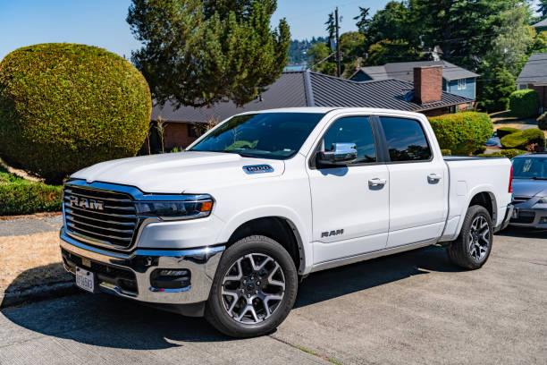 Seattle, WA, USA -July 3, 2024: 2025 RAM 1500 LARAMIE CREW CAB 4X4 5'7' BOX white, side corner view.