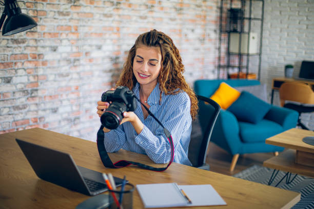 istock Young woman watching online live tutorial to learn how to use a photo camera 2183686500
