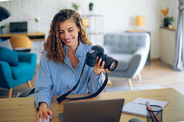 istock Young woman watching online live tutorial to learn how to use a photo camera 2183686514