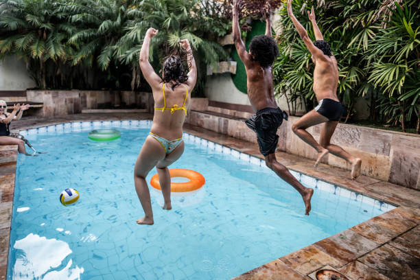 istock Young friends jumping on pool during party at home 2183690934