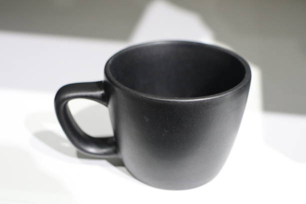 This is a stylish black ceramic cup that is perfect for enjoying coffee, tea, or even for decorative purposes