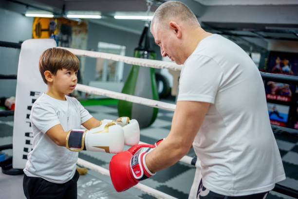 istock Father and son bonding through boxing training in a gym. 2183693182