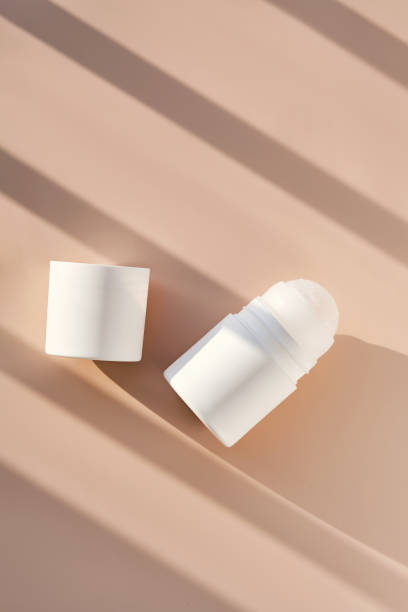 istock Roll-on deodorant on a purple background with shadow stripes. 2183696989