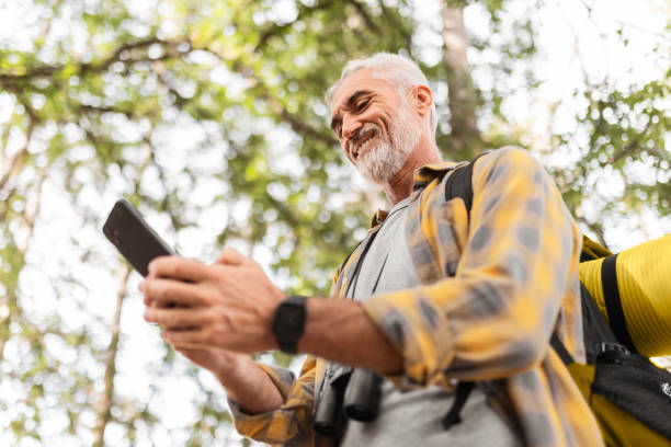 istock Smiling Man Hiking and Using His Phone 2183697236