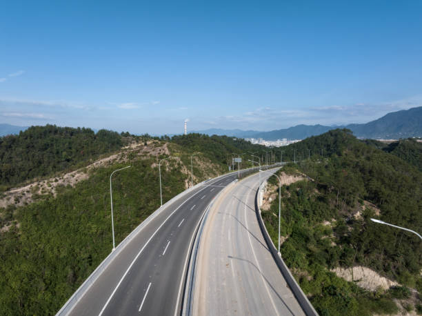 istock aerial view of highway through green mountains 2183697402