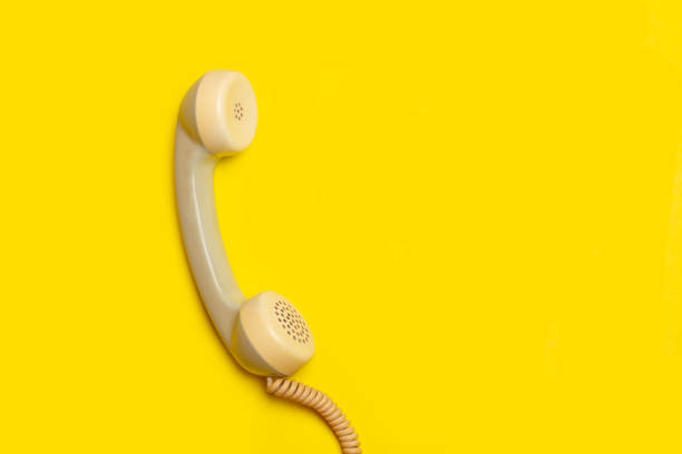 istock Vintage telephone handset on a yellow background with copy space 2183698442