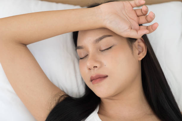 istock Young Asian woman sleeping on bed and keeping eyes closed while covered with blanket in bedroom. Asian woman sleep and lying on bed in bedroom in the morning. Healthcare concept 2183708162