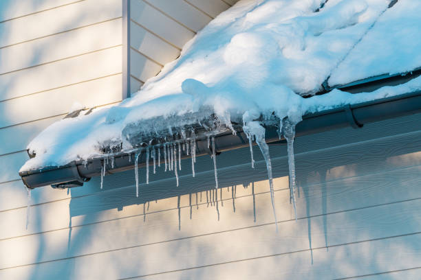 istock Icicles near the rain gutter on the roof 2183708351