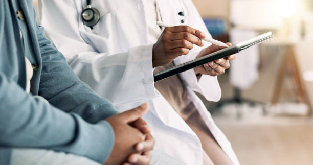istock Tablet, hands and patient with doctor for checkup with cold, flu and sickness symptoms. Digital technology, conversation and person with healthcare worker for medical consultation in clinic. 2183708456