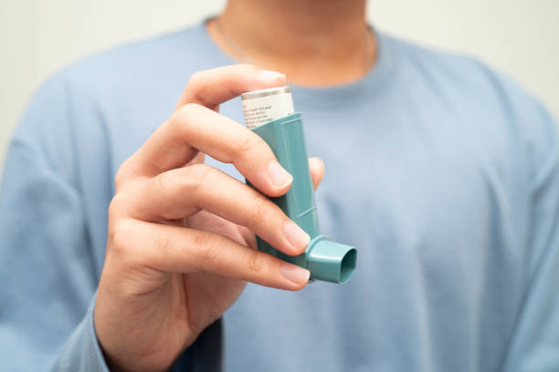 istock Asthma and chronic obstructive pulmonary disease COPD, Asian young man using metered dose inhaler MDI. 2183709404