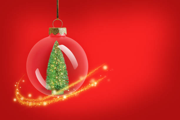 A creative and festive arrangement of red Christmas baubles in the shape of a Christmas tree, topped with a single golden ornament. The background is a sparkling silver texture, enhancing the holiday spirit. This minimalistic yet elegant design embodies the joy and warmth of the Christmas season.
