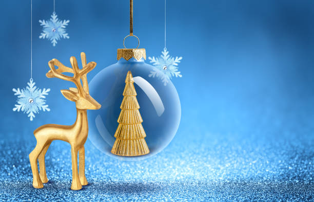 istock Christmas bauble with gold tree decoration inside, snowflakes and deer statuette. New Year ornaments on blue sparkling background. 2183710681
