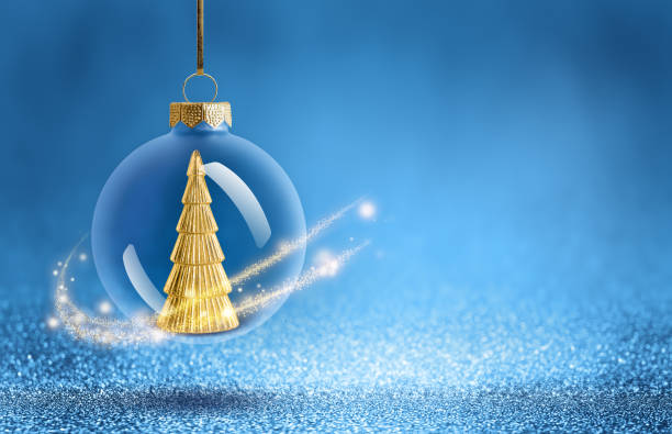 istock Christmas bauble with gold tree decoration inside. New Year ornaments on blue sparkling background. 2183710861