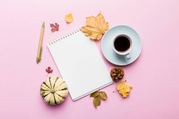 istock Autumn composition: fallen leaves and craft sketchbook mock up on colored background. Top view. Flat lay with copy space 2183712109