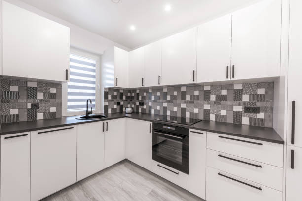 istock Scandinavian Style Cozy Modern Open Bright Kitchen Home Interior. Faucet, Fridge, Oven, Closet and Furniture in Background. LED Light, Black and White Style 2183712458