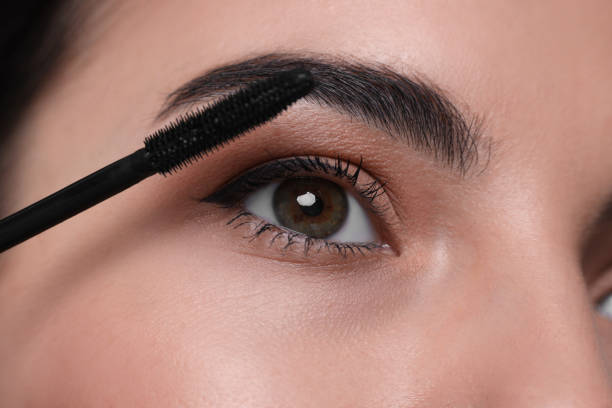 istock Beautiful young woman applying mascara, closeup view 2183713949
