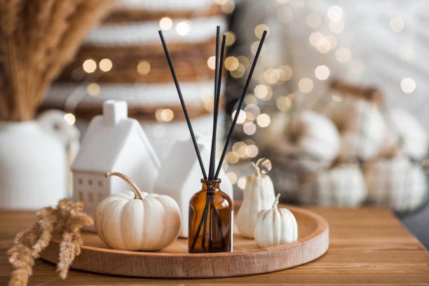 istock Aroma diffuser. Autumn scented perfumes for the home in a glass bottle with sticks as an air freshener in the house and pumpkins. Aromatherapy, cozy atmosphere, comfort and relaxation. 2183714601